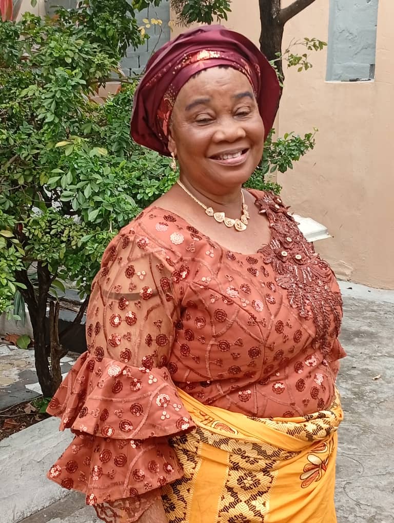 Florence reading her Bible in front of a window